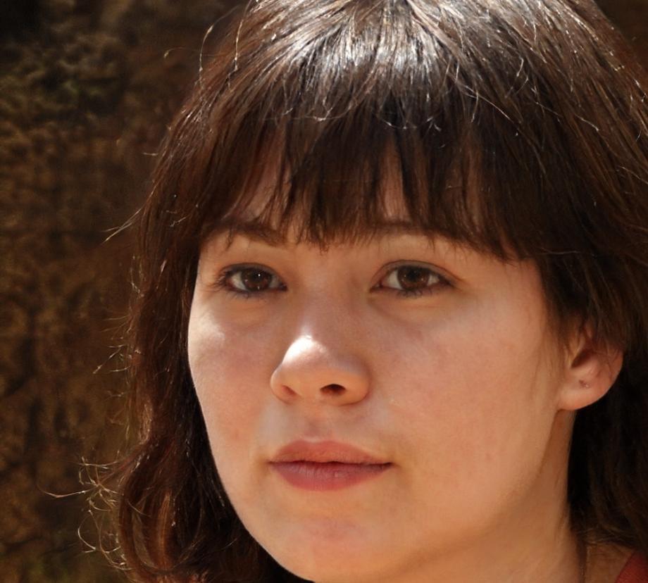 Web developer reviewing code on multiple monitors